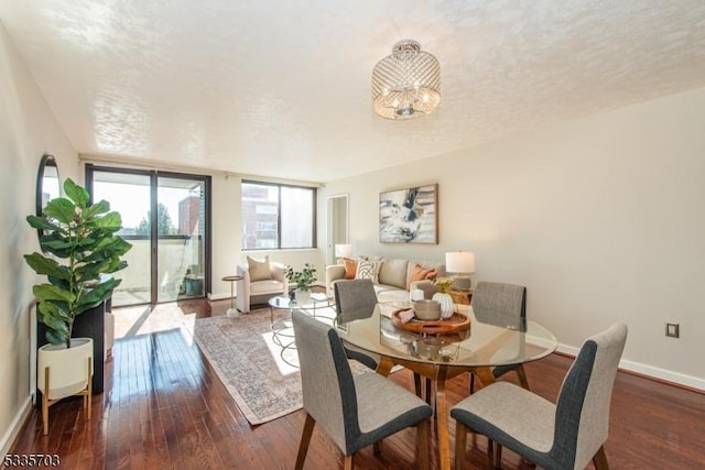 dining area featuring dark hardwood / wood-style flooring and a textured ceiling