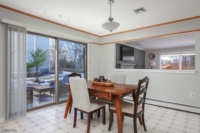 dining space with crown molding