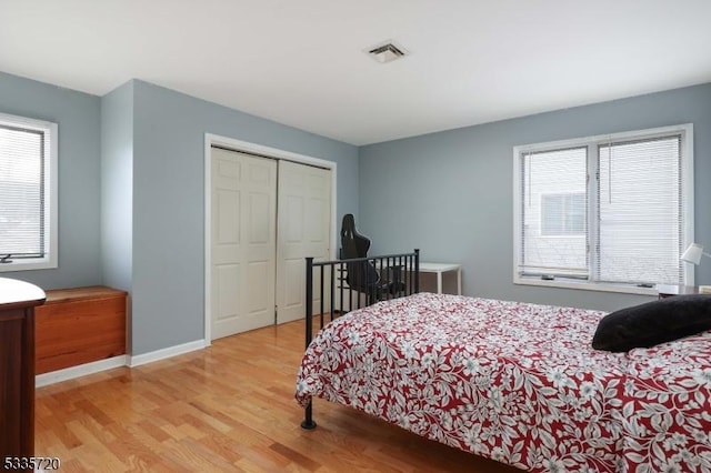 bedroom featuring light hardwood / wood-style floors and a closet