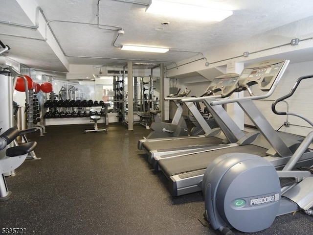 exercise room with a textured ceiling