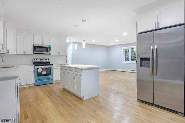 kitchen featuring white cabinetry, hanging light fixtures, and stainless steel appliances