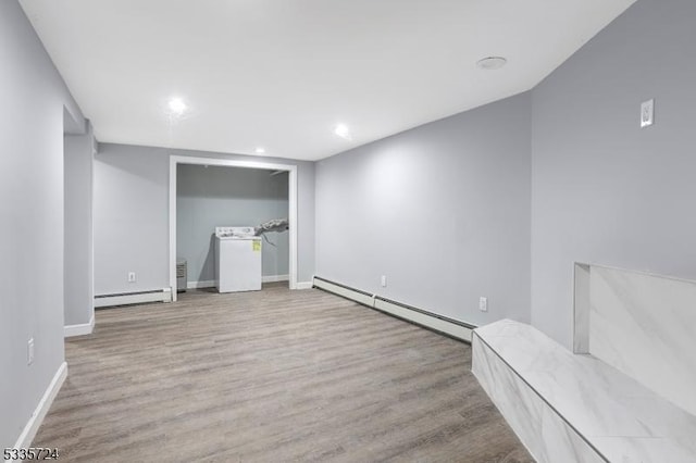 unfurnished bedroom featuring a baseboard radiator and light hardwood / wood-style floors