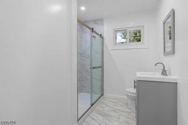 bathroom featuring vanity, toilet, and a shower with shower door