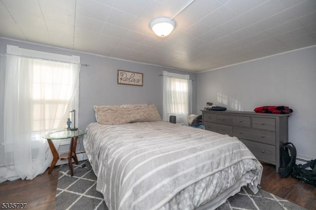 bedroom with dark hardwood / wood-style floors