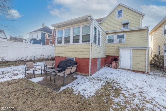 view of snow covered rear of property