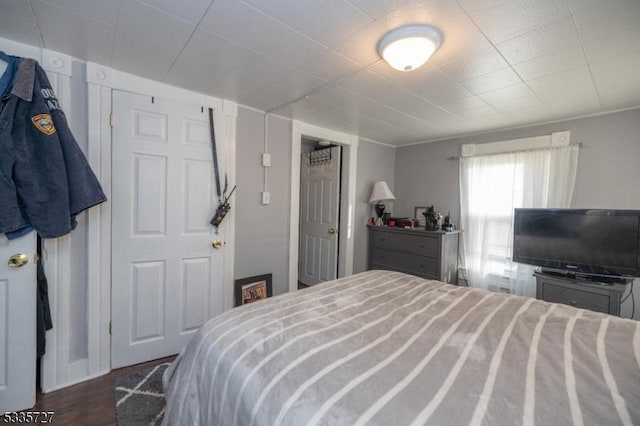 bedroom with dark hardwood / wood-style flooring