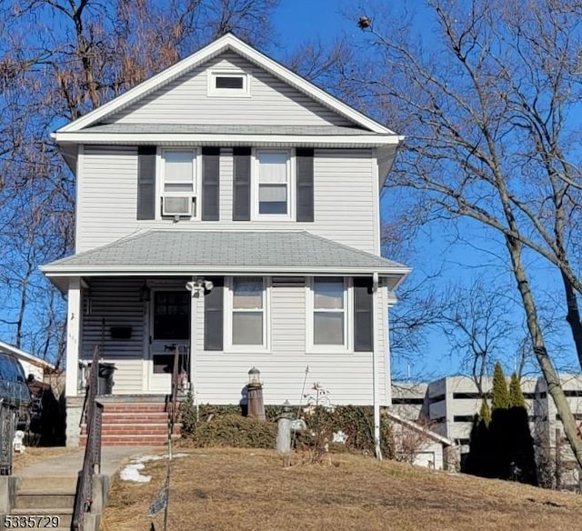 view of front of home with cooling unit and a porch