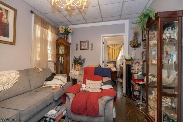 living room with hardwood / wood-style flooring and a paneled ceiling