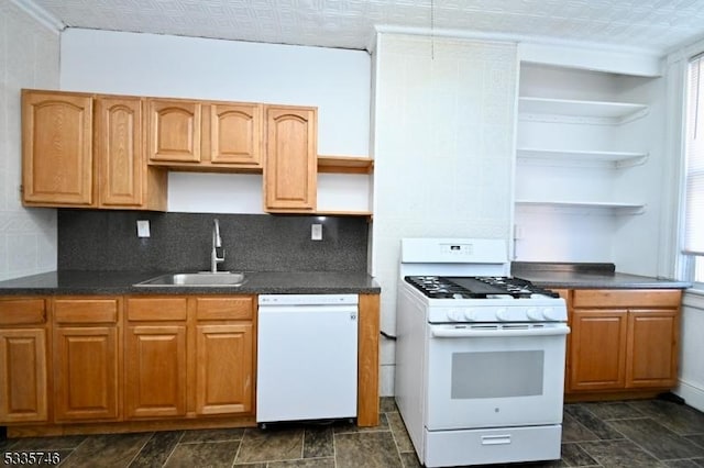 kitchen featuring tasteful backsplash, a healthy amount of sunlight, sink, and white appliances