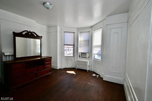 entrance foyer featuring dark wood-type flooring and radiator heating unit