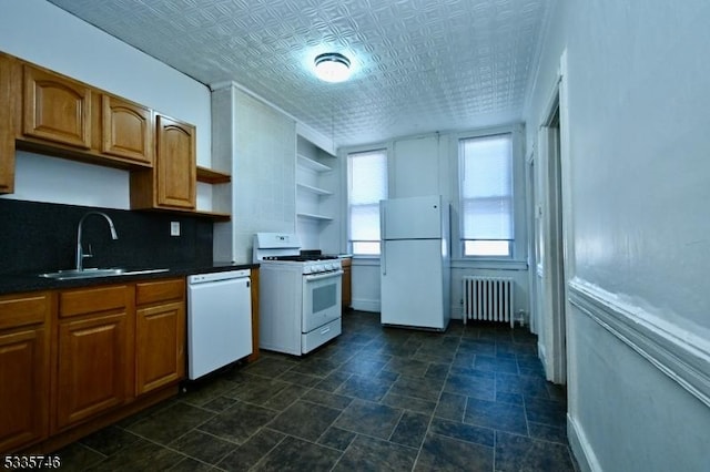 kitchen with radiator, white appliances, sink, and decorative backsplash