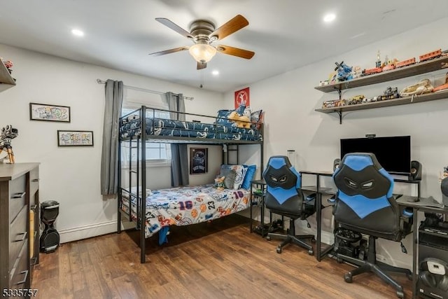 bedroom featuring hardwood / wood-style floors, a baseboard radiator, and ceiling fan