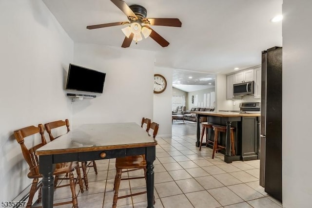 dining room featuring light tile patterned floors and ceiling fan