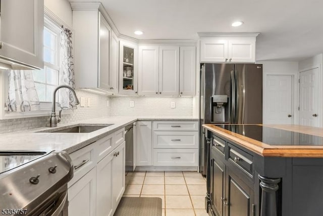 kitchen with appliances with stainless steel finishes, sink, and white cabinets