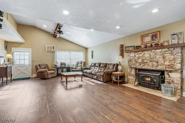 living room with lofted ceiling, a wall mounted air conditioner, hardwood / wood-style flooring, and ceiling fan