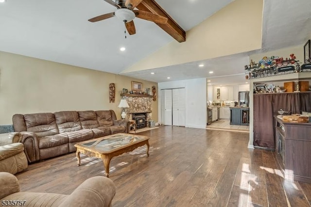 living room featuring ceiling fan, light hardwood / wood-style flooring, high vaulted ceiling, and beamed ceiling