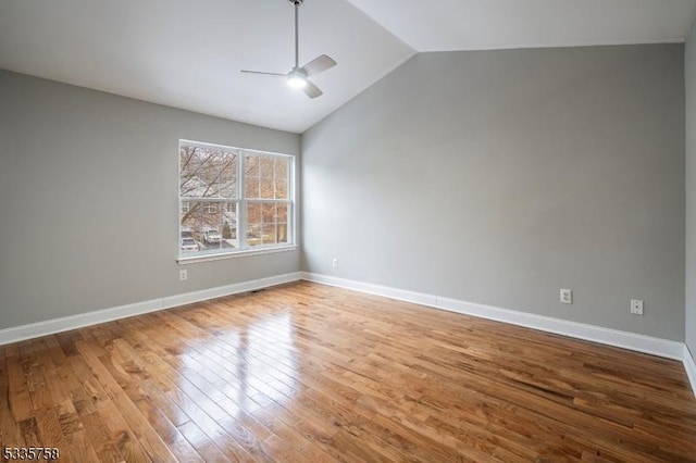 spare room featuring lofted ceiling, wood-type flooring, and ceiling fan