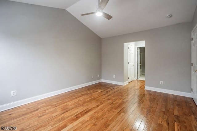 spare room featuring vaulted ceiling, ceiling fan, and light wood-type flooring