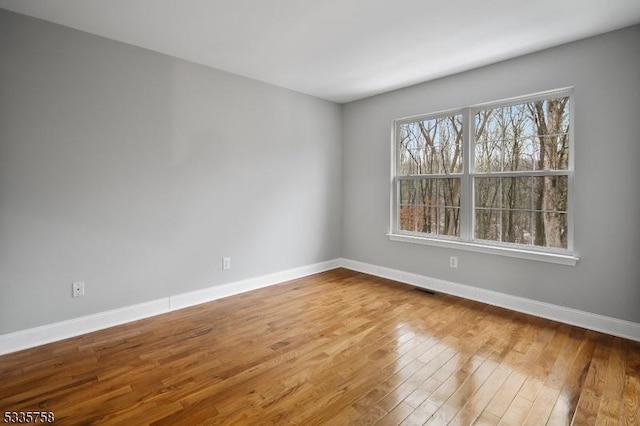 empty room with hardwood / wood-style floors