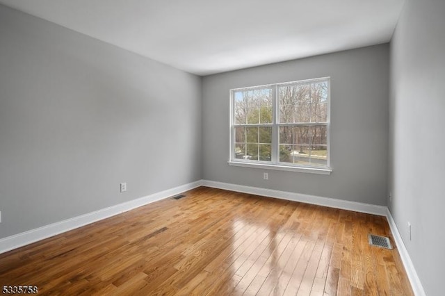 spare room with light hardwood / wood-style flooring