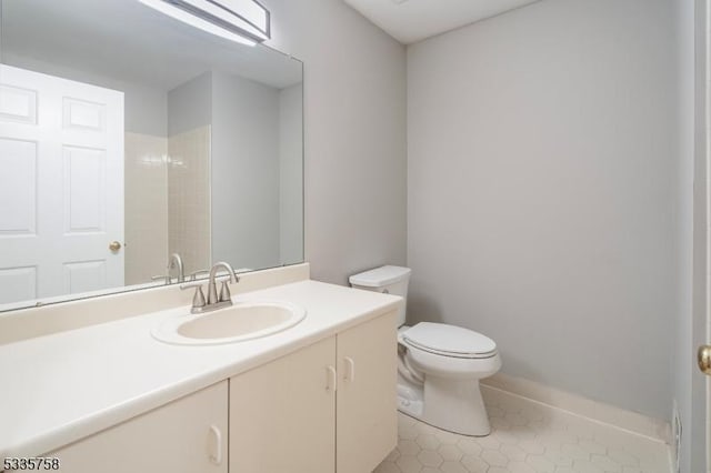 bathroom with vanity, tile patterned floors, and toilet