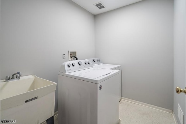 laundry area with sink and washer and dryer