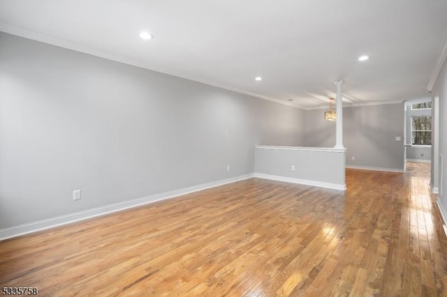 unfurnished living room featuring crown molding and light wood-type flooring