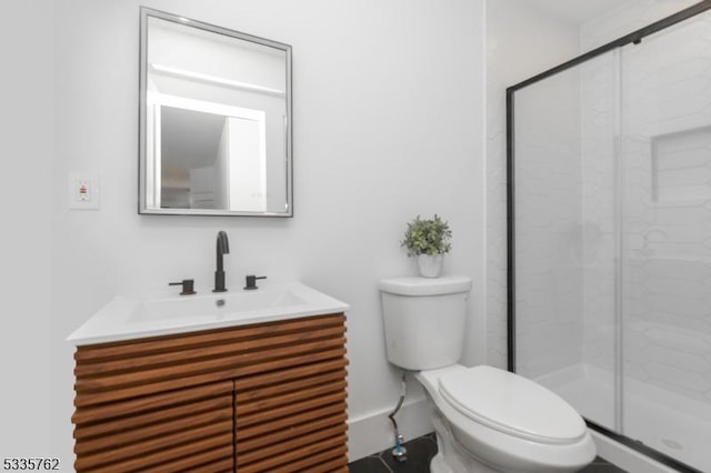 full bath featuring toilet, a shower stall, and vanity