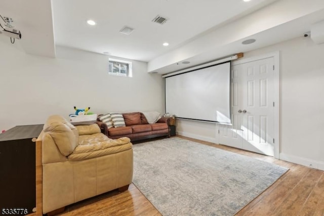 home theater room with hardwood / wood-style flooring