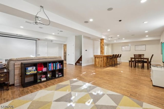 interior space with bar and light hardwood / wood-style flooring