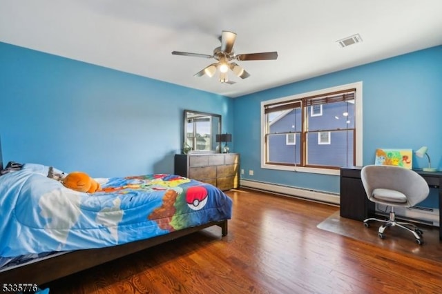 bedroom featuring a baseboard heating unit, hardwood / wood-style floors, and ceiling fan