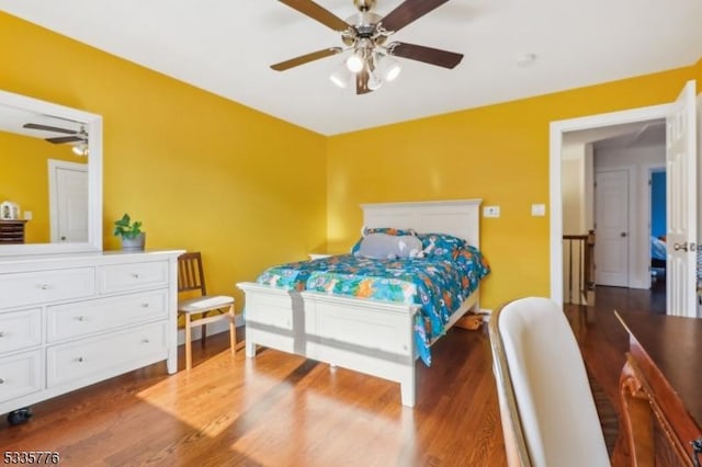 bedroom with ceiling fan and dark hardwood / wood-style flooring