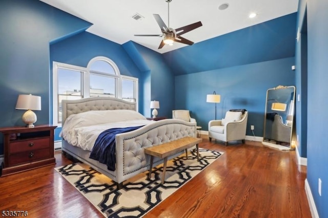 bedroom featuring ceiling fan, lofted ceiling, and dark hardwood / wood-style flooring