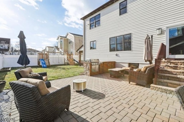 view of patio / terrace featuring a playground, a grill, and an outdoor living space