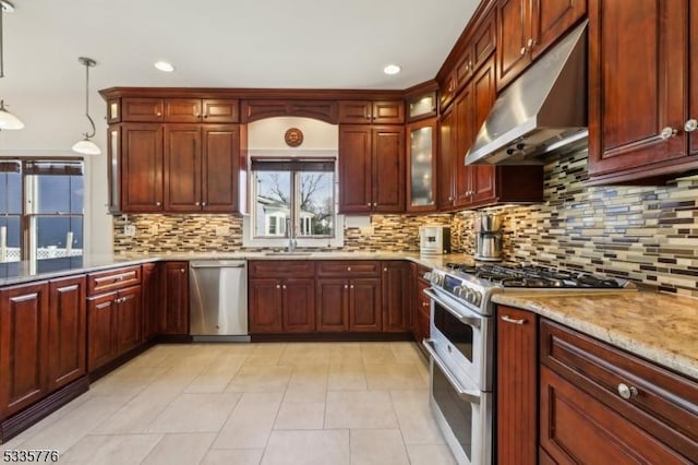 kitchen featuring sink, light tile patterned floors, hanging light fixtures, stainless steel appliances, and decorative backsplash