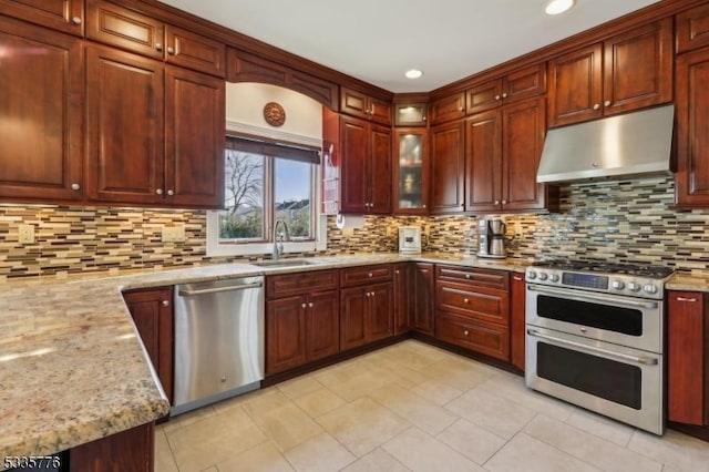 kitchen featuring sink, decorative backsplash, light tile patterned floors, light stone counters, and stainless steel appliances