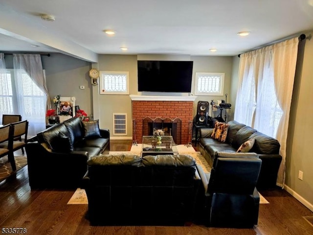 living room with a fireplace and dark hardwood / wood-style floors