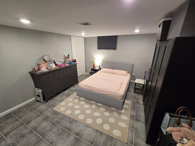 bedroom with dark tile patterned flooring