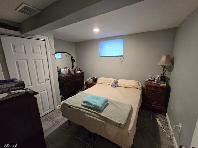 bedroom with dark tile patterned flooring