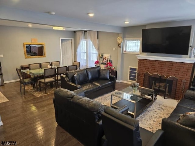 living room with a fireplace and dark hardwood / wood-style flooring