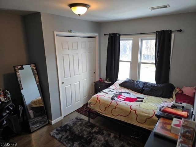 bedroom featuring dark hardwood / wood-style floors and a closet