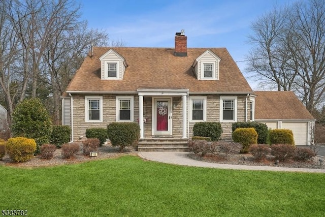 cape cod home with a garage, stone siding, a chimney, and a front lawn