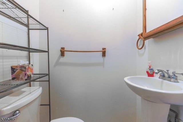 bathroom with toilet and a sink