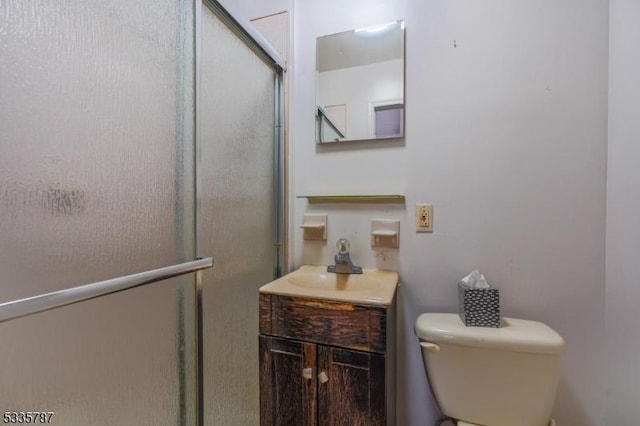 full bath featuring vanity, toilet, and a shower stall