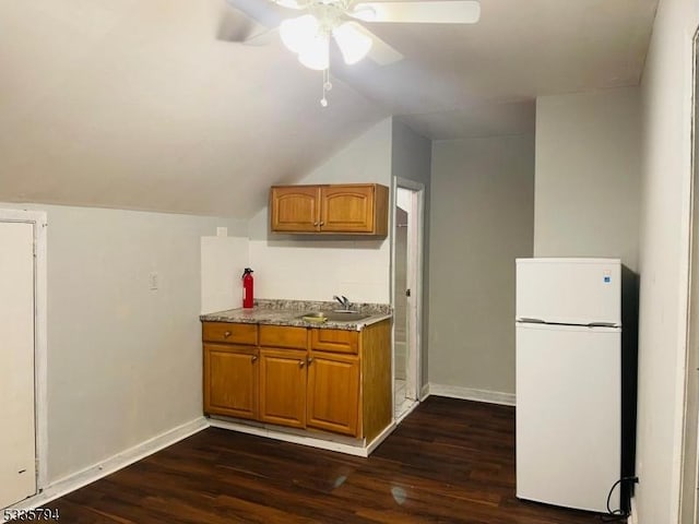 kitchen with white refrigerator, lofted ceiling, sink, and dark hardwood / wood-style floors