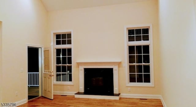 unfurnished living room with wood-type flooring