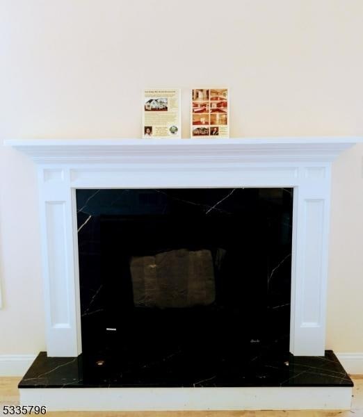 interior details with baseboards and wood finished floors