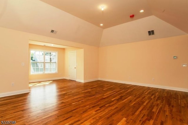 unfurnished room with lofted ceiling and wood-type flooring