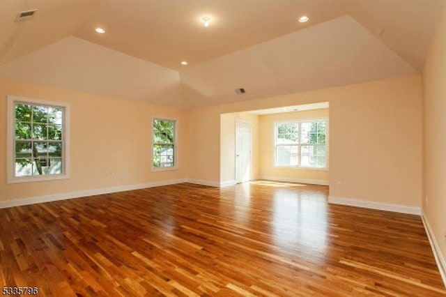 unfurnished room featuring vaulted ceiling and wood-type flooring