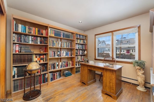 office area featuring a baseboard radiator and light wood-style flooring